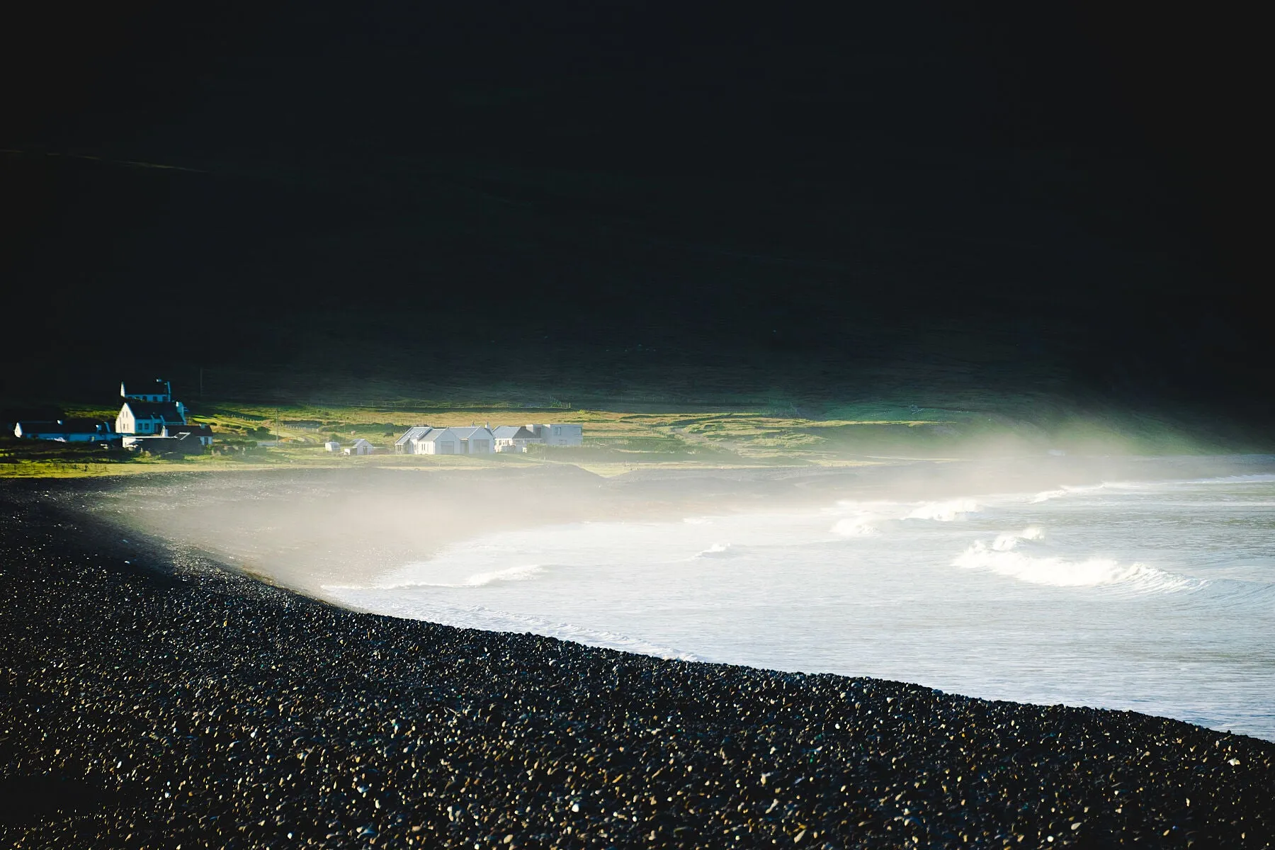 As the sun rose at Keel Beach on Achill Island, the dramatic hills surrounding the bay blocked most of the early light. Here the first rays of the morning sun are starting to reach the beach.
